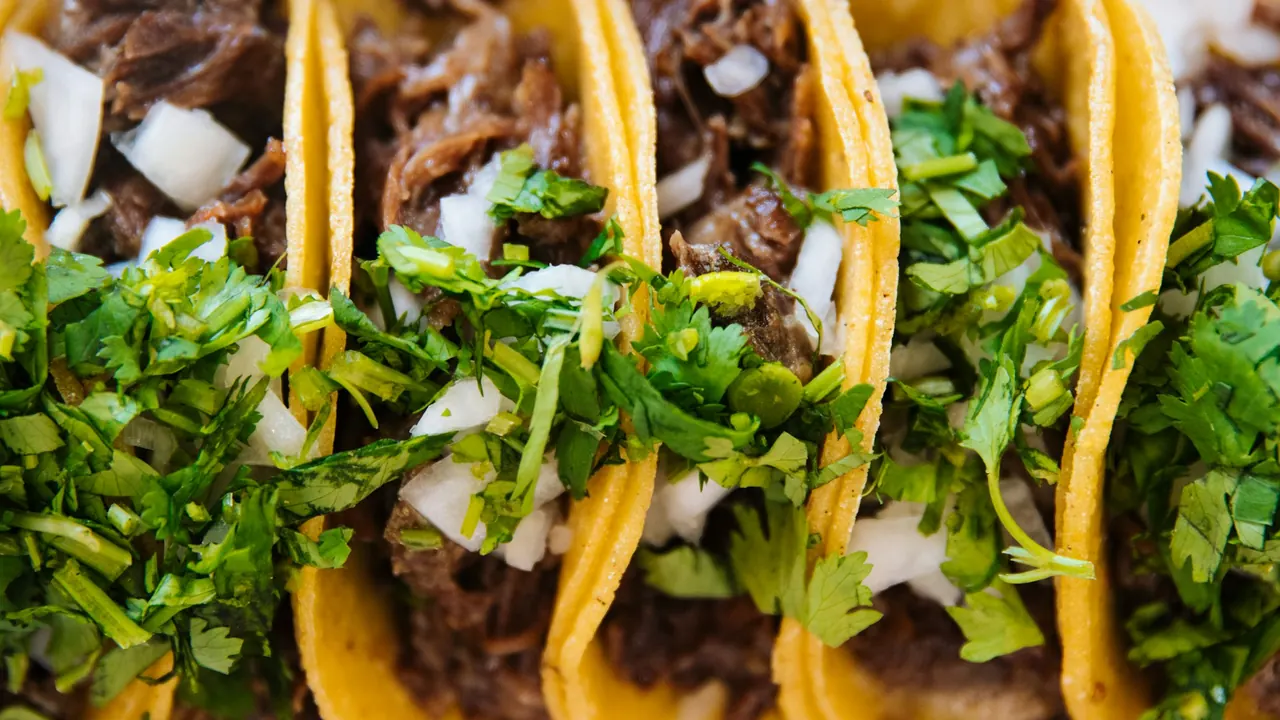Close-up of carne asada street tacos with cilantro and onion
